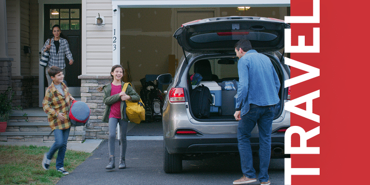 a family loads up bags into their vehicle with the text overlay "travel"